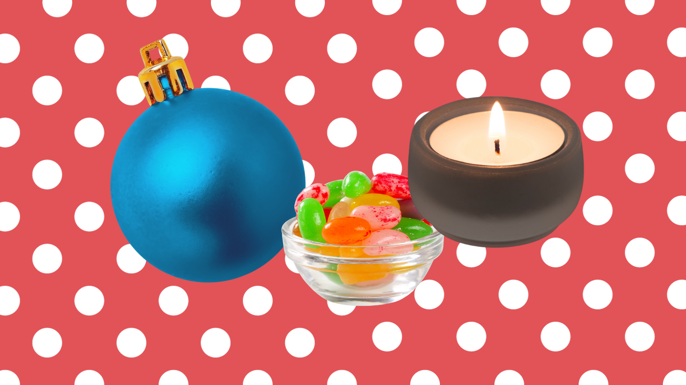 Ornament, candle and jelly beans on red background
