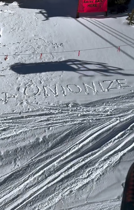 The word “unionize” written in a snowbank below a ski lift.