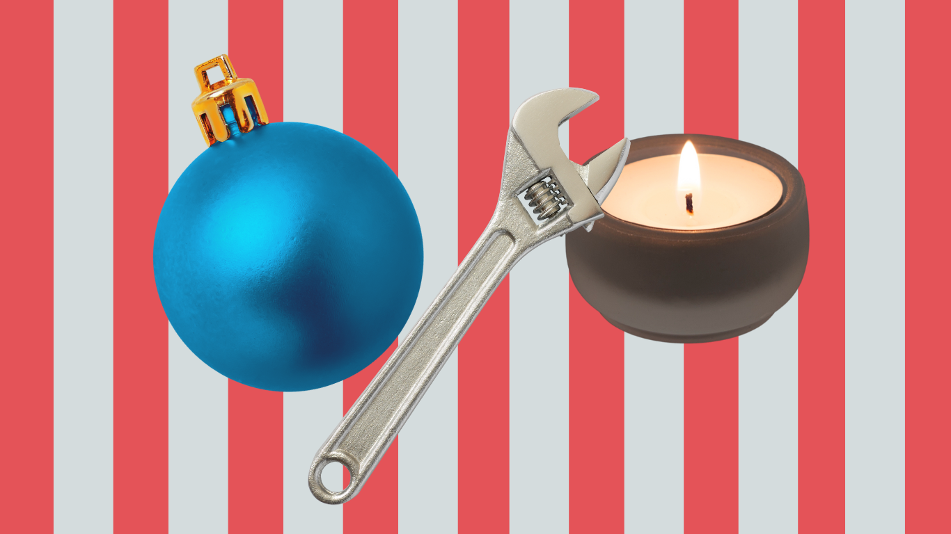 An ornament, candle and wrench on a red striped background