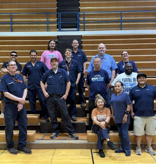 Workers posing together for a group picture.