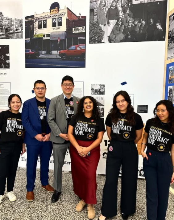 AAJCollective members posing for a group photo and wearing shirts that call for a fair contract.