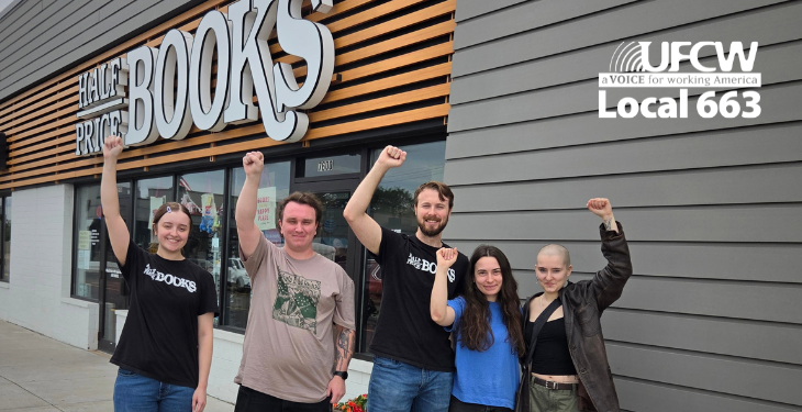 Half Price Books workers pose for a group picture in front of the store.